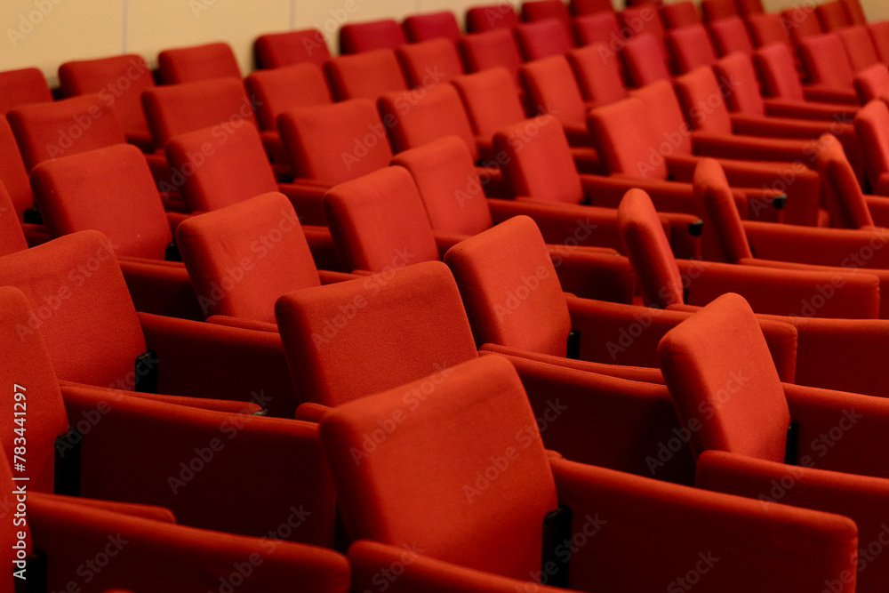 close rows of red armchairs in the conference room close rows of red armchairs in the conference room