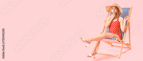 Surprised young woman sitti...