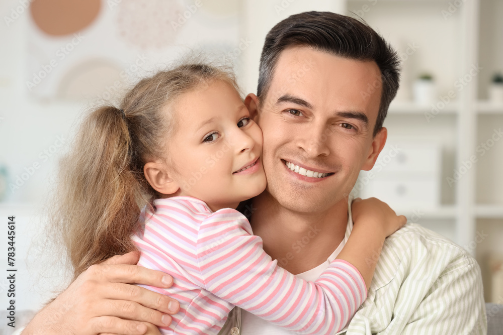 Cute little girl hugging her dad at home, closeup