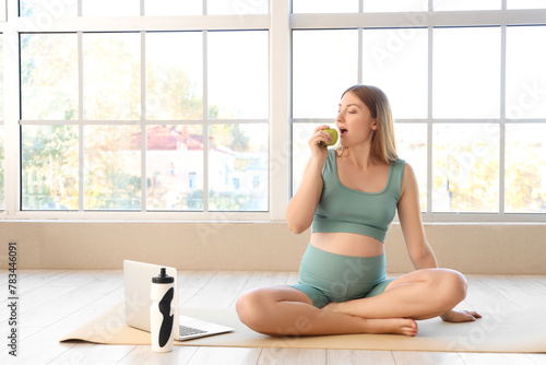 Pregnant woman eating green...