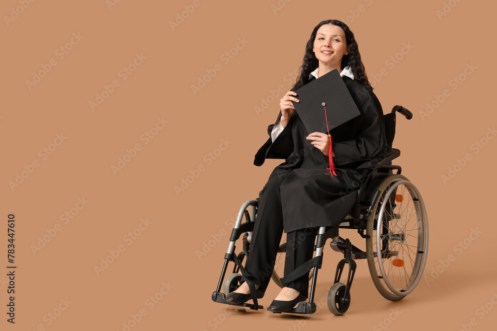 Beautiful female graduate student in wheelchair with graduation cap on brown background Beautiful female graduate student in wheelchair with graduation cap on brown background