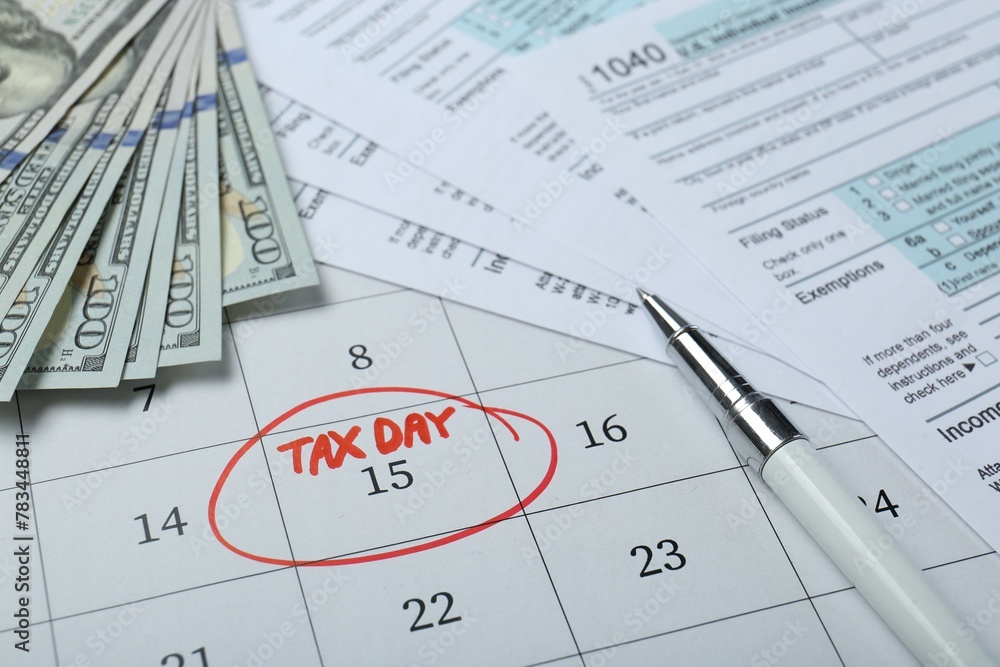 Calendar with date reminder about tax day, documents, pen and money, closeup Calendar with date reminder about tax day, documents, pen and money, closeup