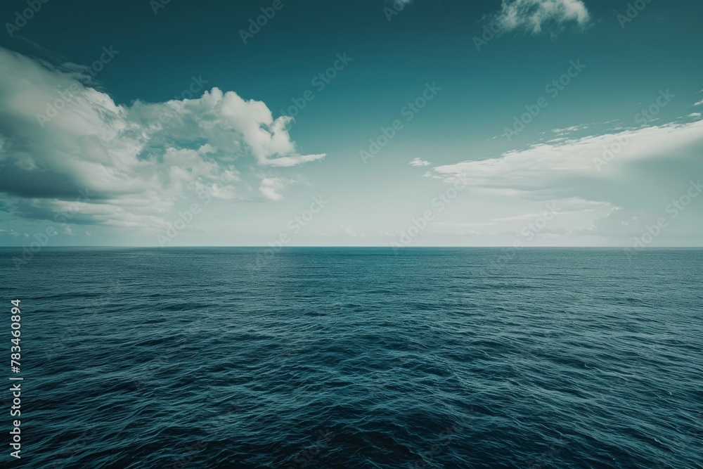 Obraz premium Ocean horizon with calm blue waters under a serene sky, ideal for tranquil nature backgrounds.