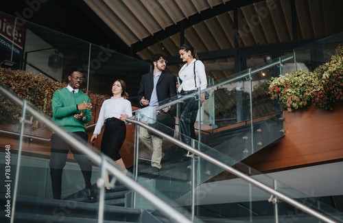 A diverse group of business colleagues discuss marketing strategies and business expansion while walking down stairs outdoors.