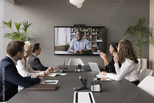 Male applicant pass job interview remotely using video call. Group of HR managers interviewing African candidate through videoconference. Communication using videocall app, virtual business meeting