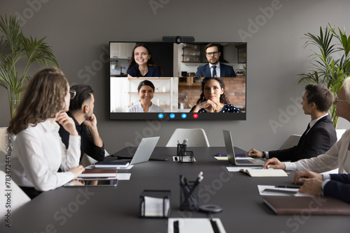 Four applicants on monitor screen, HR managers listen candidates at remote job interview, virtual meeting. Video call application usage for negotiations and business communication. Telemeeting event