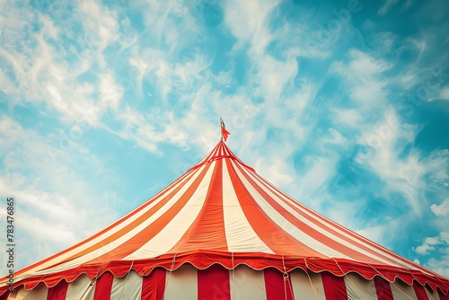 Circus tent peak against blue sky. Clowncore, circus aesthetics concept. Happy atmosphere. Banner, poster with copy space. 