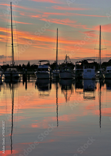 Boats moored at Lakes Entrance harbour south east Victoria during a brilliant pink sunset