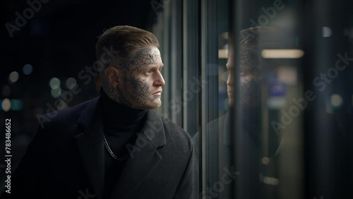 Attention-seeking Tattooed Male Person Standing on Urban City Street photo