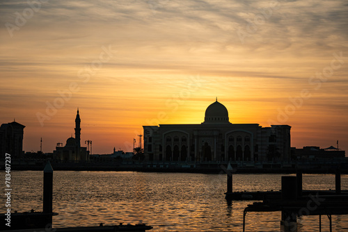 Beautiful sunrise on sea in Sharjah. beautiful buildings of Arab architecture on the background of an evening sunset
