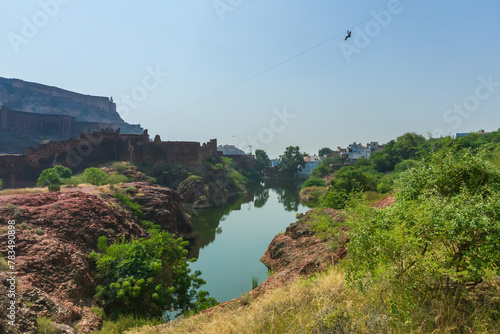 View of Mehrangarh fort from Rao Jodha desert rock park, Jodhpur, India. Desert rocks in foreground and Mehrangarh fort in the background, with rocky landscape of the desert park. photo