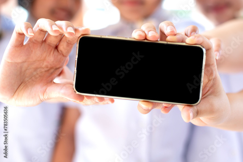 Girls' hands holding a smartphone together Blank black screen