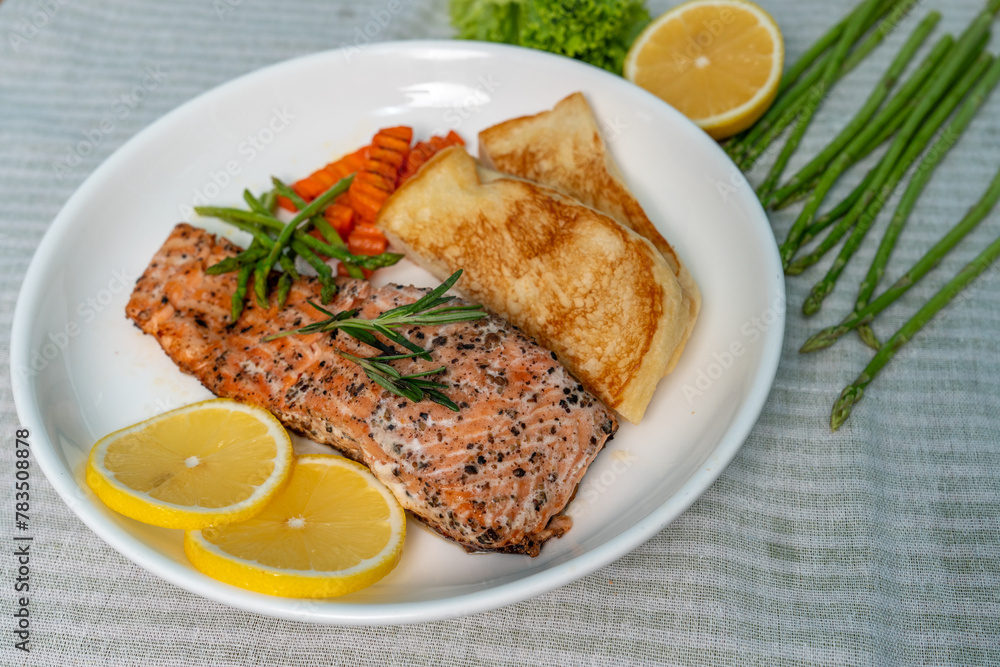 Salmon Steak with Butter Toast Ready to eat on a wooden table. Salmon Steak with Butter Toast Ready to eat on a wooden table.