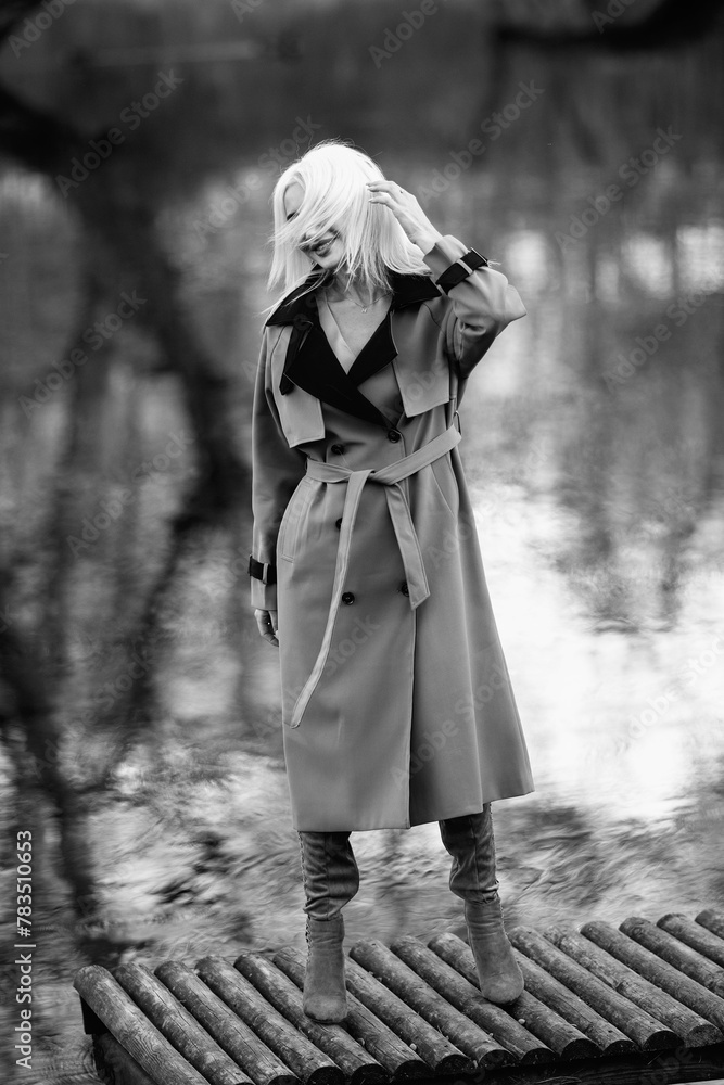 Portrait of a young beautiful blonde girl outdoors. Black and white photo. Portrait of a young beautiful blonde girl outdoors. Black and white photo.
