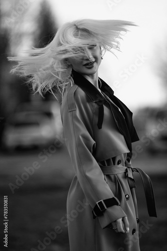 Portrait of a young beautiful blonde girl outdoors. Black and white photo.