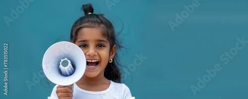 Happy Eastern Indian girl holding a megaphone © FATHOM