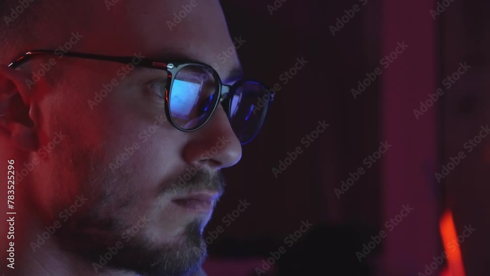 A Man with Glasses in Front of the Monitor. Eyes Running Across the Screen. A Businessman with Glasses Looks at the Exchange Chart. A Man with Glasses in Front of the Monitor. Eyes Running Across the Screen. A Businessman with Glasses Looks at the Exchange Chart.