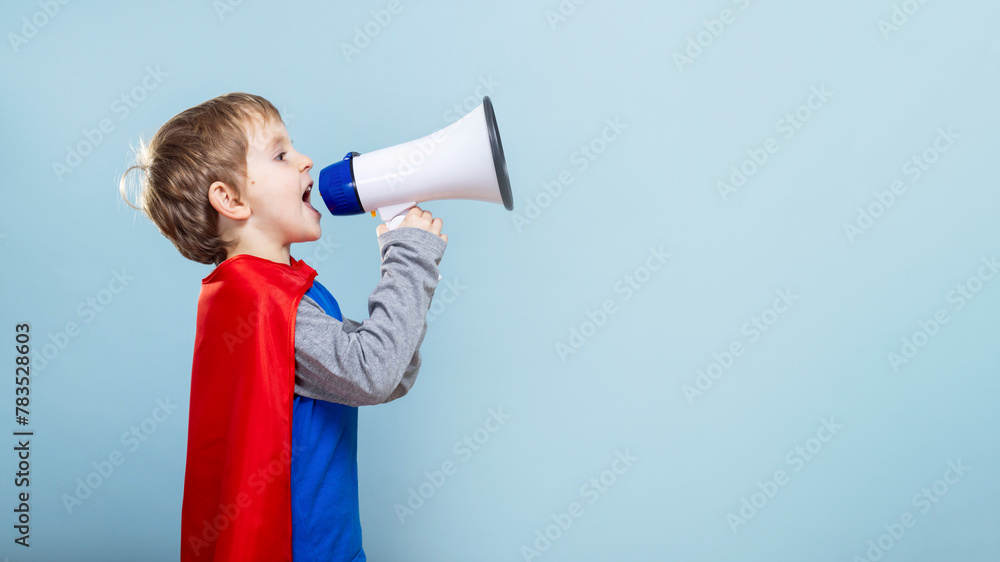 Young boy in superhero costume shouting into megaphone. Young boy in superhero costume shouting into megaphone.