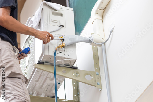 Technician man install new air conditioner, Repairman service for repair and maintenance of air conditioners