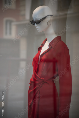 Closeup of red dress on mannequin in a fashion store showroom