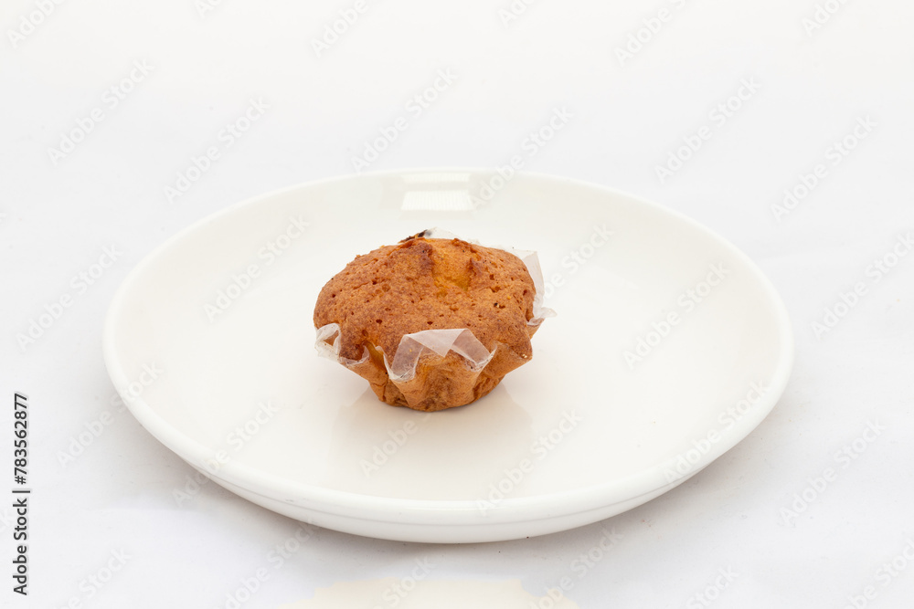 A single cupcake in plate on white background A single cupcake in plate on white background