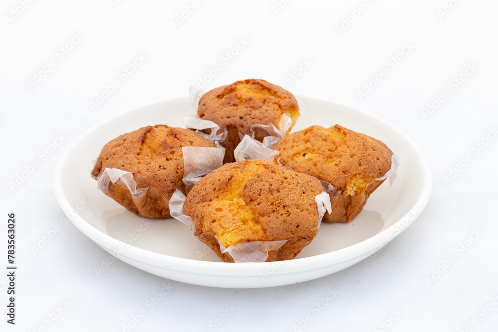 Fresh small cakes in ceramic plate on white background Fresh small cakes in ceramic plate on white background