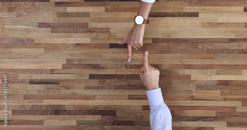 Man and woman pointing finger at each other from above photo
