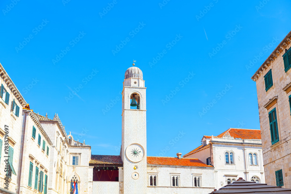 The bell tower of the Church of St. Nicholas in Dubrovnik, Croatia. Clocktower at Luza Square in Dubrovnik  - obrazy, fototapety, plakaty 