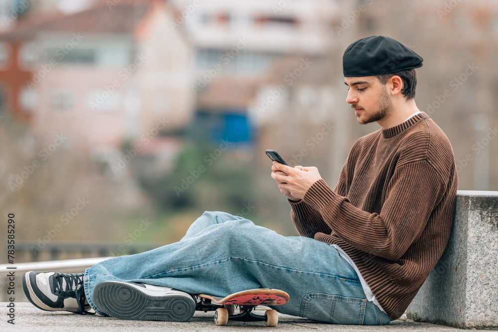 young man on the street with mobile phone and skateboard young man on the street with mobile phone and skateboard