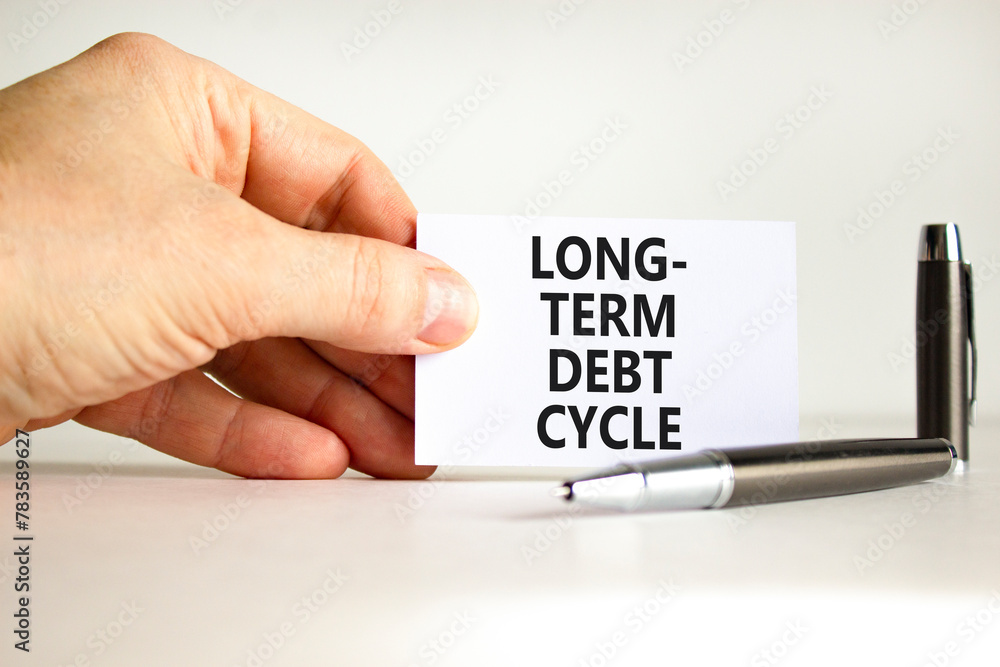 Long-term debt cycle symbol. Concept words Long-term debt cycle on beautiful white paper. Beautiful white background. Businessman hand. Business Long-term debt cycle concept. Copy space. Long-term debt cycle symbol. Concept words Long-term debt cycle on beautiful white paper. Beautiful white background. Businessman hand. Business Long-term debt cycle concept. Copy space.