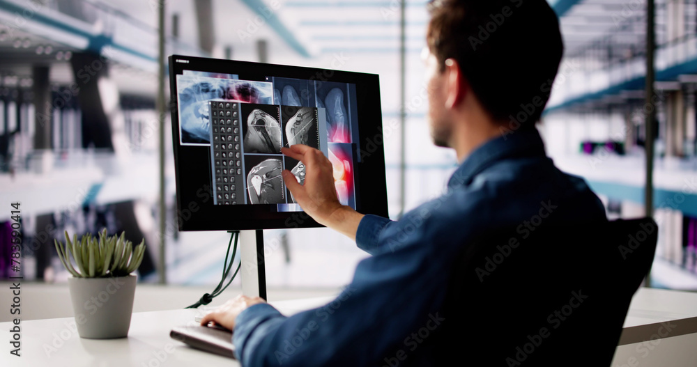 Mature Male Dentist Looking At Teeth X-ray On Computer Mature Male Dentist Looking At Teeth X-ray On Computer