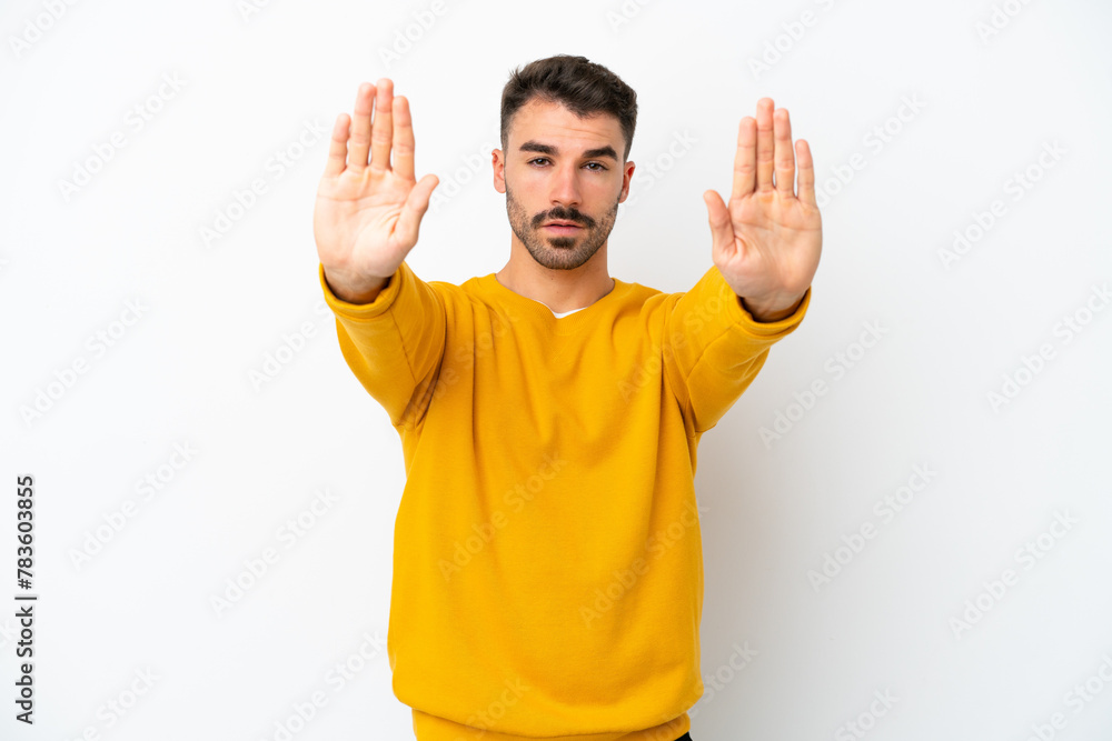 Young caucasian man isolated on white background making stop gesture and disappointed Young caucasian man isolated on white background making stop gesture and disappointed