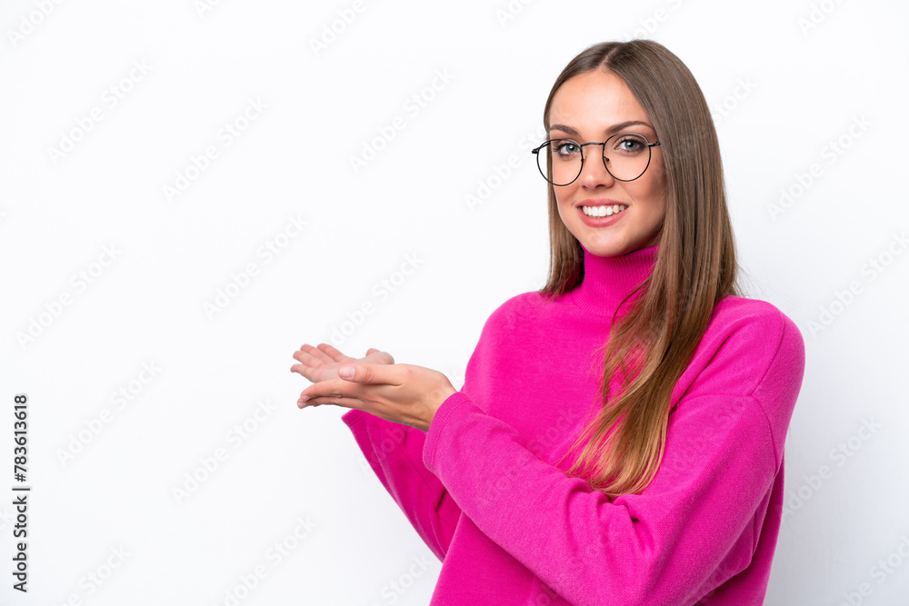 Young caucasian woman isolated on white background extending hands to the side for inviting to come Young caucasian woman isolated on white background extending hands to the side for inviting to come