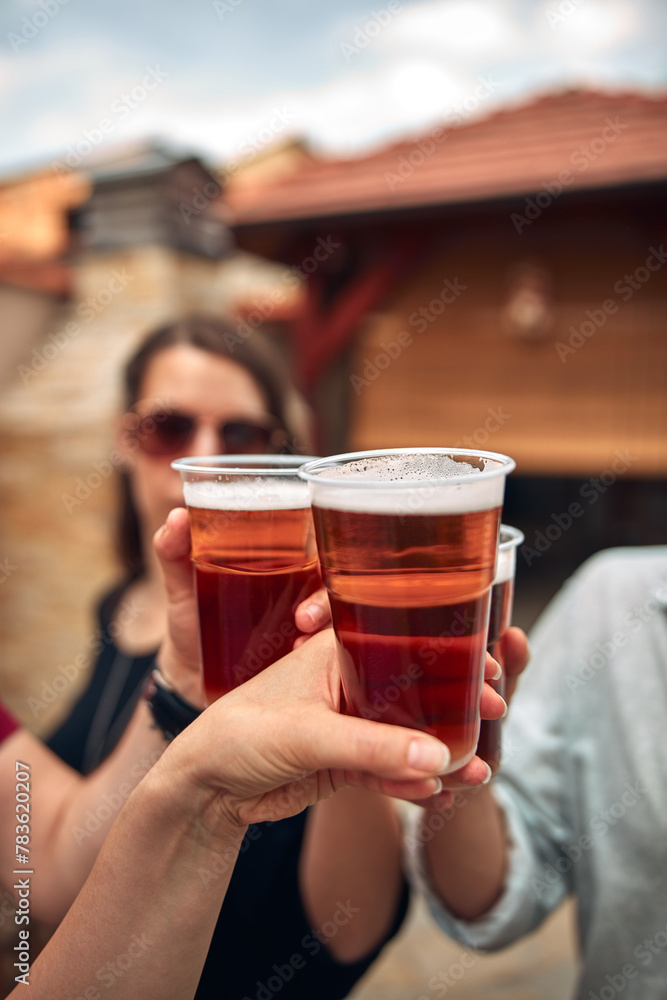 Group of friends enjoying cold beer at a backyard party. Group of friends enjoying cold beer at a backyard party.