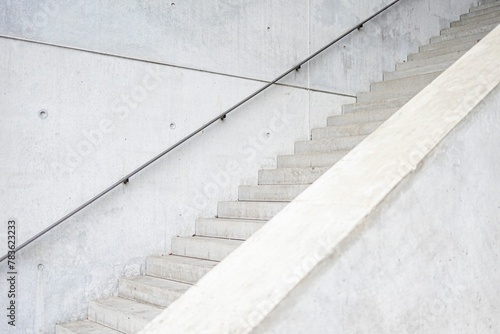 Stone staircase with metal railings in a bright white atmosphere. photo