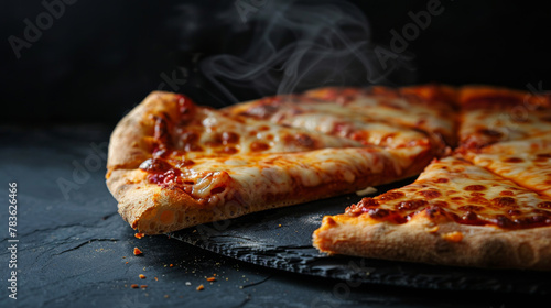 Steaming hot New York style pizza slice with melting cheese, on slate plate, isolated on dark background. 