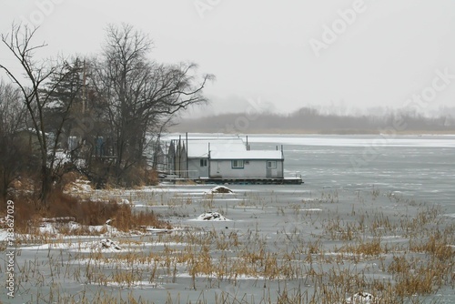 Beautiful shot of house boats moored on the pier of the frozen Mississippi River