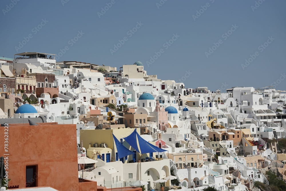Beautiful scene of the white houses and a church in the daytime in Santorini, Greece