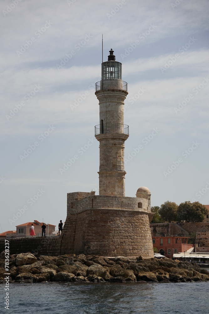 Vertical shot of the white Lighthouse of Chania by the sea in Chania, Crete, Greece