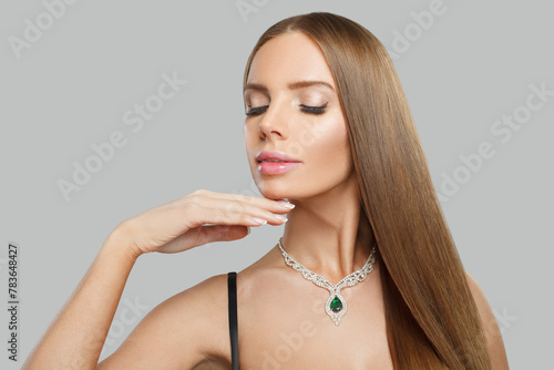 Fashionable jewelry model beautiful woman portrait. Brunette woman with long smooth hair and necklace