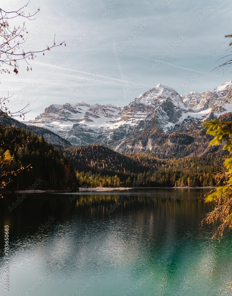 Naklejka premium View of the lake and the reflection of trees of the mountains on the water.