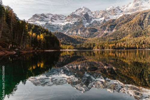 View of the lake and the reflection of trees of the mountains on the water. photo