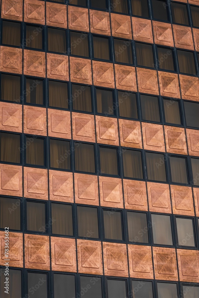 Vertical shot of the facade of a hotel building with framed windows Vertical shot of the facade of a hotel building with framed windows