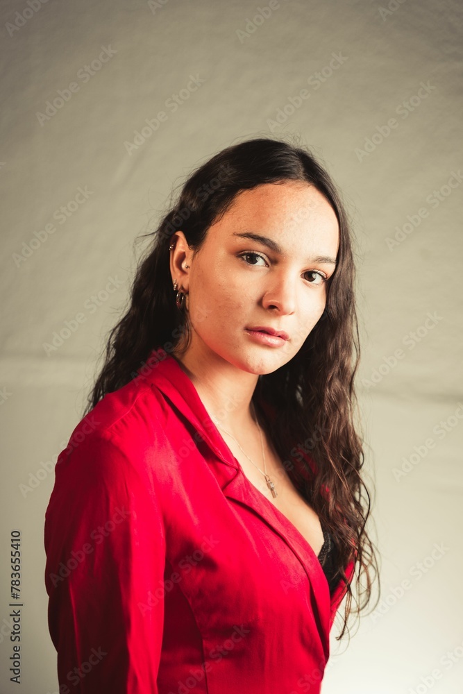Vertical shot of a young caucasian woman in a red suit Vertical shot of a young caucasian woman in a red suit
