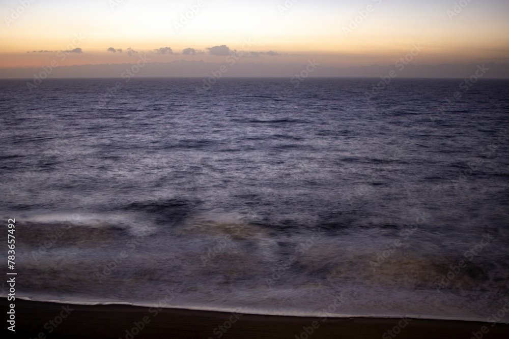 Fototapeta premium Beautiful shot of a bright sunset sky over the blue sea