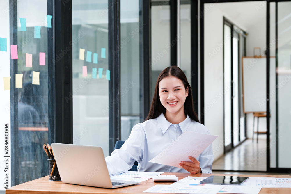 Smiling Businesswoman with Documents at Office Desk Smiling Businesswoman with Documents at Office Desk