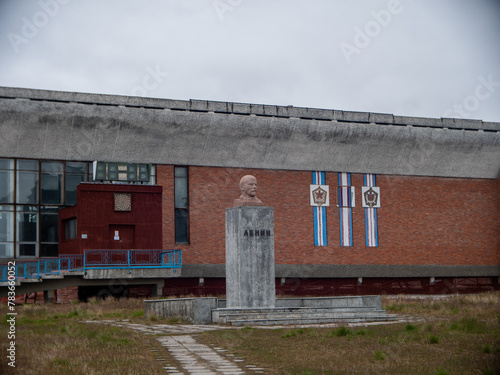 View of the bust of V.I. Lenin in front of an abandoned soviet coal mining in Svalbard, Spitsbergen photo