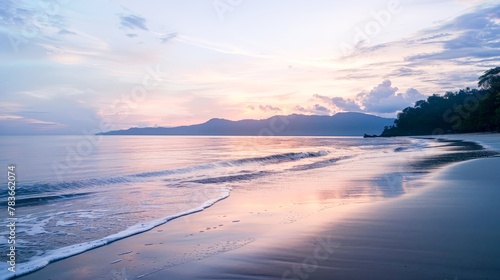 A serene beach at dawn, the sky painted in soft pastels, inviting a moment of peaceful reflection by the sea.