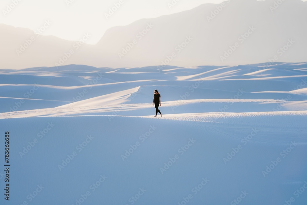 Female in black clothing walking at White Sands National Park, New Mexico