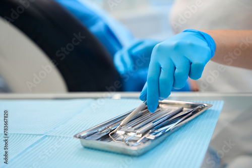 Dentist at workplace using sterile instruments